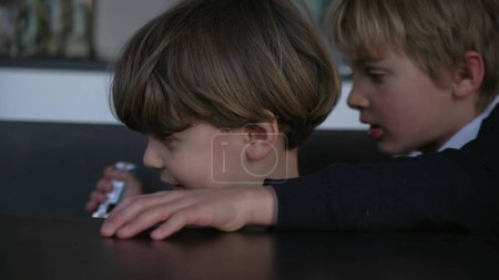Photo for Two little boys fighting over toy car. Older brother wanting to take vehicle object from sibling - Royalty Free Image