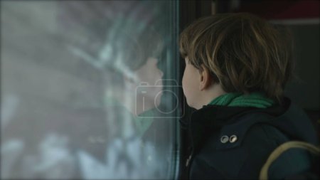 Photo for Little Boy by Train Window Observing as it Enters Tunnel, Child Passenger on High-Speed Journey - Royalty Free Image