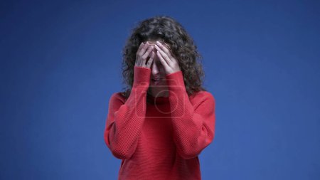 Photo for Woman covering face with regret, anxious preoccupied 20s person feeling anguish and annoyance during mental pressure - Royalty Free Image