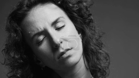Photo for Person experiencing stiff neck, woman having body pain in black and white - Royalty Free Image