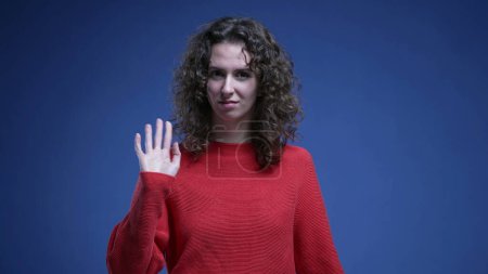 Photo for Baffled woman reacting to accusation with surprise, pointing finger to herself rejecting recrimination - waving finger "not me" body language - Royalty Free Image