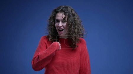 Photo for Surprised young woman pointing finger to herself feeling delighted when chosen as winner. 20s female person reacting to GREAT accomplishment - Royalty Free Image