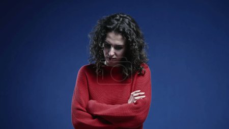 Photo for Fearful woman crossing arms feeling afraid and scared. Negative protective boduy language, feeling depressed and apprehensive - Royalty Free Image