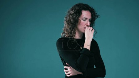 Photo for Nervous Person Biting Nails and fidgeting Amid Mental Pressure, woman struggles with anxiety - Royalty Free Image