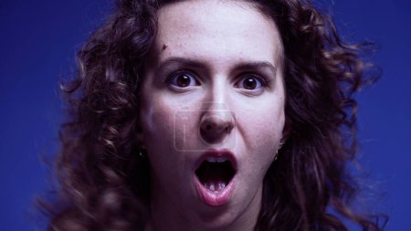 Photo for Shocked woman open mouth reaction looking at camera and sideways in disbelief. Amazed emotion of person reacts to unbelievable news - Royalty Free Image