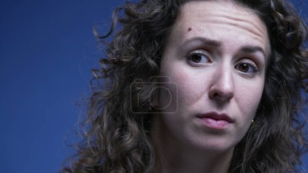 Photo for Woman in doubt listening close-up face with question mark expression lifting eye brow feeling confused - Royalty Free Image