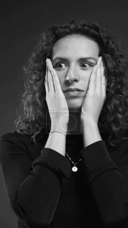 Photo for Despairing Woman Covering Face, Expression of Regret in dramatic monochromatic black and white - Royalty Free Image