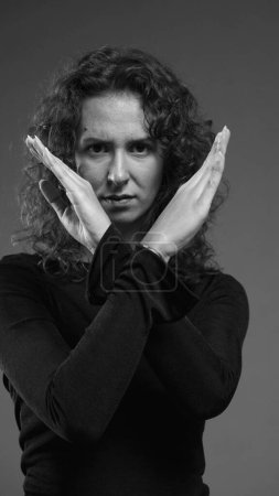 Photo for Woman pointing finger to camera in accusation. Viewer POV perspective of person rejecting offer, black and white, monochromatic - Royalty Free Image