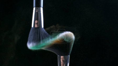 Photo for Cosmetic Brushes Clashing in Ultra Slow Motion with Orange Particle Effects captured in macro with high-speed camera - Royalty Free Image