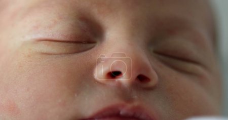 Foto de Newborn baby face closeup with eyes closed sleeping - Imagen libre de derechos
