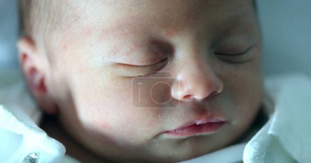 Photo for Newborn baby face closeup with eyes closed sleeping - Royalty Free Image