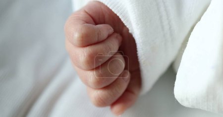 Photo for Newborn baby infant asleep, close-up of tiny little hand in macro detail - Royalty Free Image