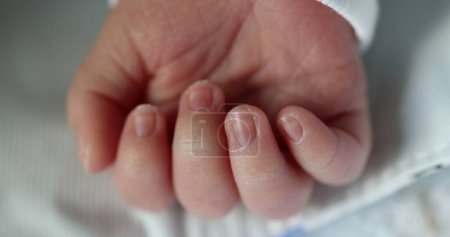 Photo for Newborn baby infant asleep, close-up of tiny little hand in macro detail - Royalty Free Image