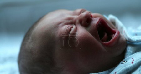 Foto de Baby crying newborn first week of life upset and angry - Imagen libre de derechos