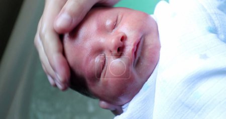 Foto de Washing newborn face face and head. infant bathing - Imagen libre de derechos