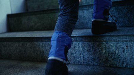 Photo for Kid in Rainboots Climbing Stairs, Ready for Rain - Royalty Free Image