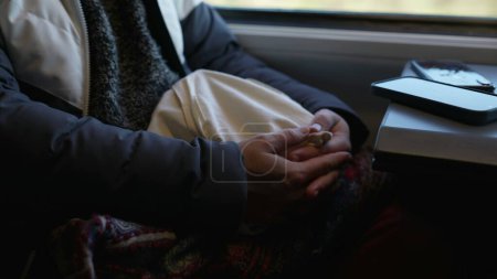 Photo for Closeup woman hands while traveling by train. pensive passenger patiently awaits to arrive in destination - Royalty Free Image