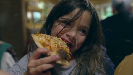 Photo for Children grabbing slice of pizza at restaurant, siblings about to eat carb food at diner. Little girl eating pizza - Royalty Free Image