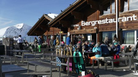 Téléchargez les photos : Grindelwald - 30 décembre 2023 - Touristes à la terrasse du restaurant sur la falaise du ciel promenade au premier sommet des Alpes suisses, Suisse, surplombant la montagne, prendre une pause de SKI - en image libre de droit