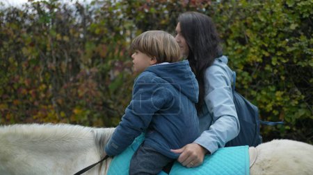Photo for 4-Year-Old Boy on Pony Ride, Supported by Mother - Royalty Free Image