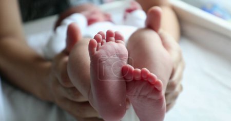 Téléchargez les photos : Baby newborn feet together after birth, frst days of life - en image libre de droit