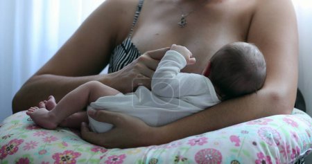 Foto de Newborn baby being held by mother after birth, infant little hand holding mother finger - Imagen libre de derechos