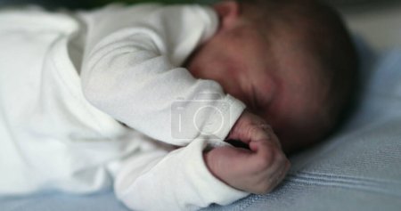 Photo for Newborn baby sleeping, infant stretching face and waking up - Royalty Free Image