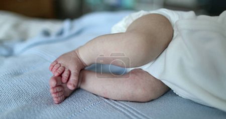 Photo for Newborn baby feet in bed sleeping, cute infant feet - Royalty Free Image