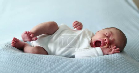 Photo for Newborn baby falling asleep taking a nap yawning and going to sleep - Royalty Free Image