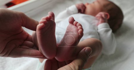 Photo for Showing newborn baby feet holding infant foot - Royalty Free Image