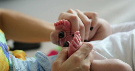 Photo for Playing with newborn baby feet and foot - Royalty Free Image