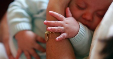 Téléchargez les photos : Baby hands holding into mom arms cute adorable sweet newborn closeup napping - en image libre de droit