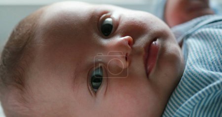 Photo for Baby newborn closeup face looking to camera - Royalty Free Image