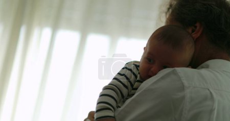 Foto de Authentic grandfather holding baby infant toddler at home - Imagen libre de derechos