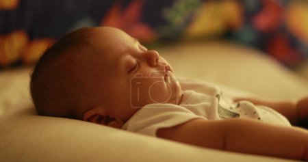Photo for Baby newborn sleeping at night in bedtime - Royalty Free Image