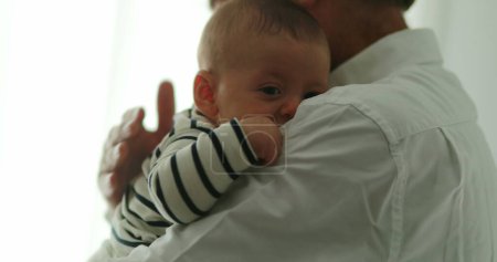 Foto de Grandparent holding grandson baby infant - Imagen libre de derechos