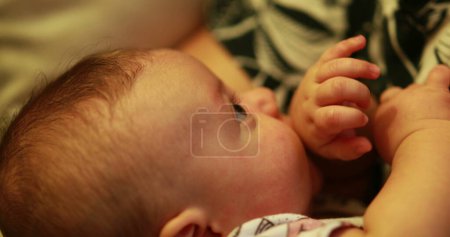 Photo for Candid moment between mom and newborn baby in evening mother smiling with infant - Royalty Free Image