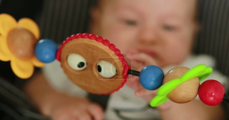 Foto de Closeup of baby toy infant spinning toy in foreground - Imagen libre de derechos