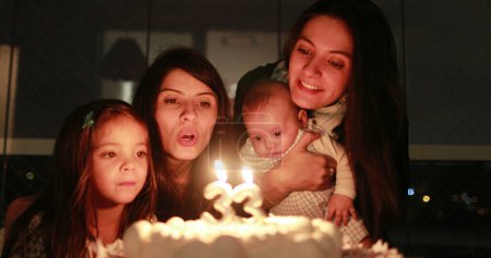 Photo for People blowing birthday cake candles - Royalty Free Image