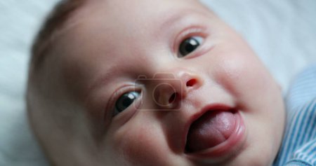 Photo for Happy newborn baby infant face closeup of expression - Royalty Free Image