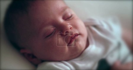 Téléchargez les photos : Infant newborn sleeping and dreaming reaction - en image libre de droit