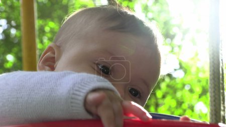 Foto de Adorable lindo bebé en el columpio del patio en el parque al aire libre - Imagen libre de derechos