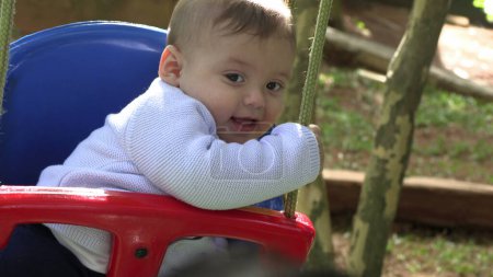 Foto de Baby boy at playground swing - Imagen libre de derechos
