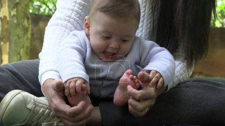 Foto de Bebé descubriendo pies infante poniendo pie en la boca auténtico - Imagen libre de derechos