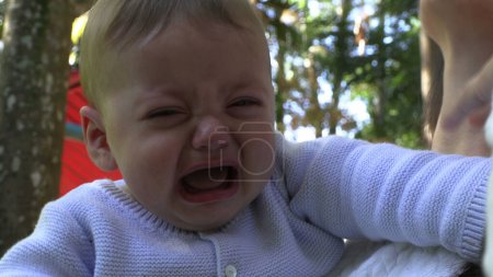 Photo for Crying baby toddler boy having a tantrum outdoors - Royalty Free Image