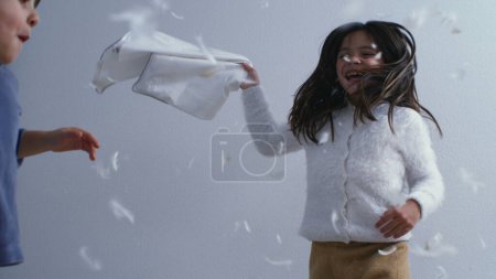 Photo for Happy Siblings in Feather-Filled Fun - Bed Bounce and Pillow Fight in Super Slow Motion at 1000 FPS - Royalty Free Image