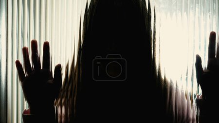 Photo for Little Girl's Silhouette Showing Sadness on Glass, Concept of Childhood Mental Health Struggles, somber moody contrast - Royalty Free Image