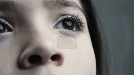 Photo for Detailed View of Young Child's Eye Gazing Upwards, Eight-Year-Old's Reflective Look - Royalty Free Image