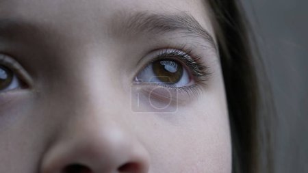 Photo for Macro close-up of child eye gazing upwards, facial eyesight feature of 8 year old child looks up in contemplation - Royalty Free Image