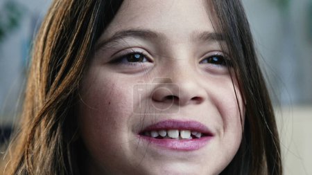 Photo for Macro close-up of child's face smiling. Happy little girl gazing in the distance - Royalty Free Image